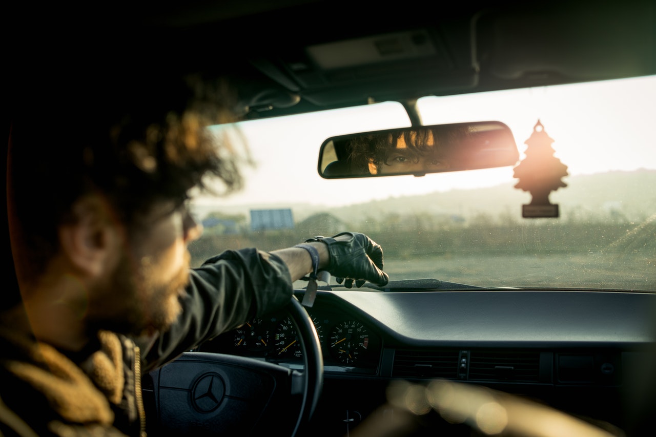 man-inside-a-car-with-reflection-on-rear-view-mirror-3476402