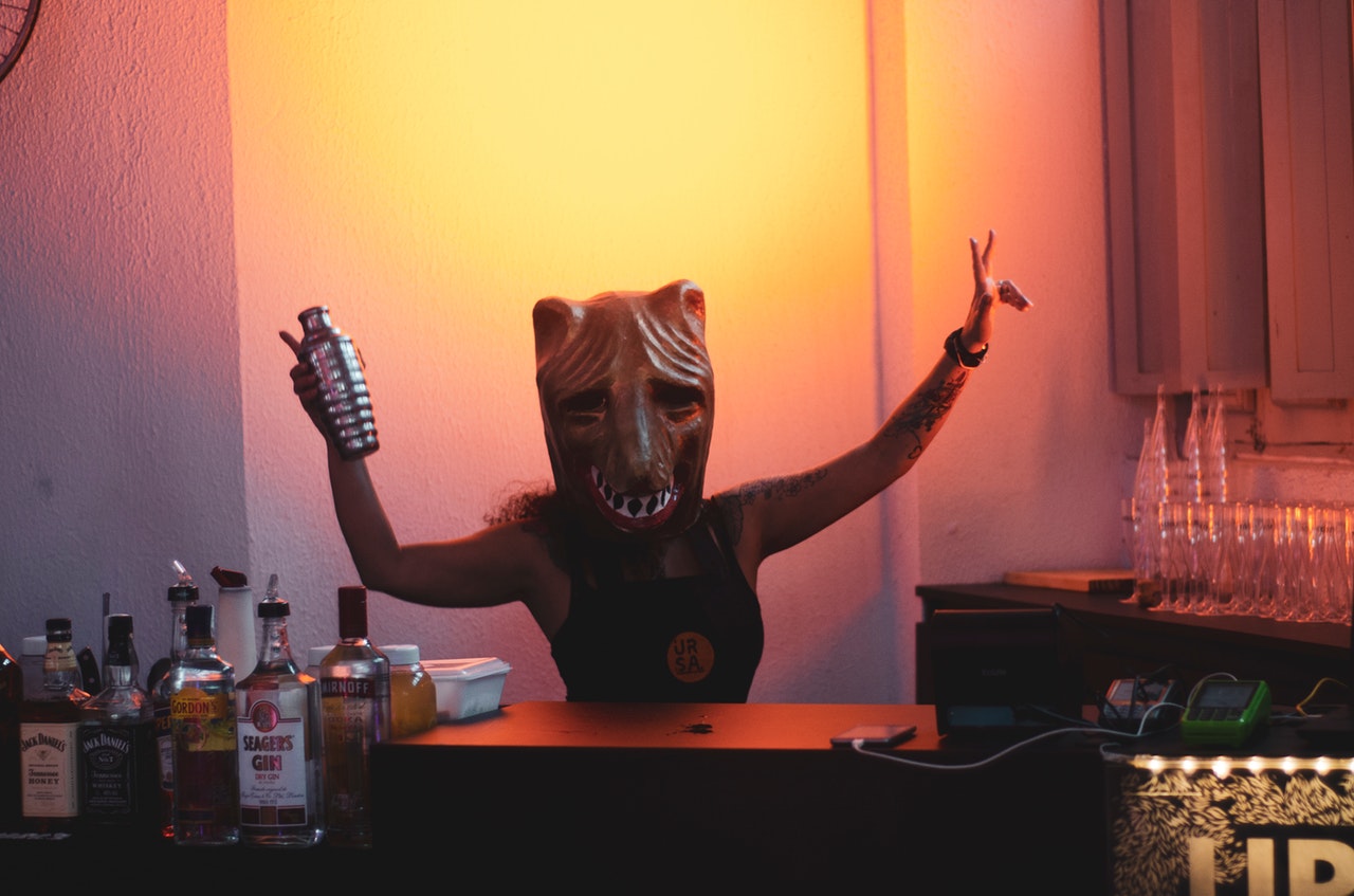 person-wearing-mask-holding-cocktail-shaker-1230397