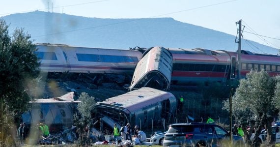 mergency services attend to the victims at the scene of a collision between two trains in Urda