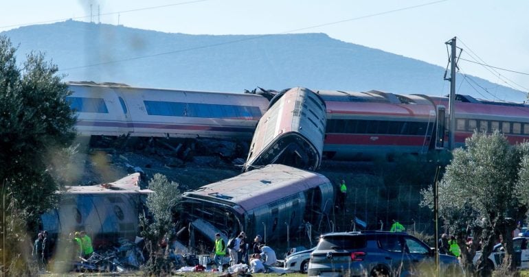 mergency services attend to the victims at the scene of a collision between two trains in Urda